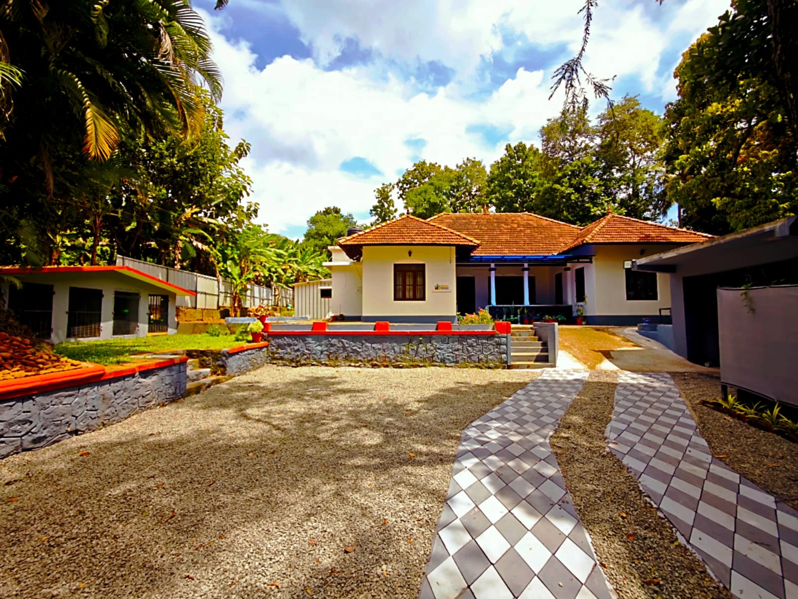 Golden Retreat’s courtyard, tiled walkway, and building